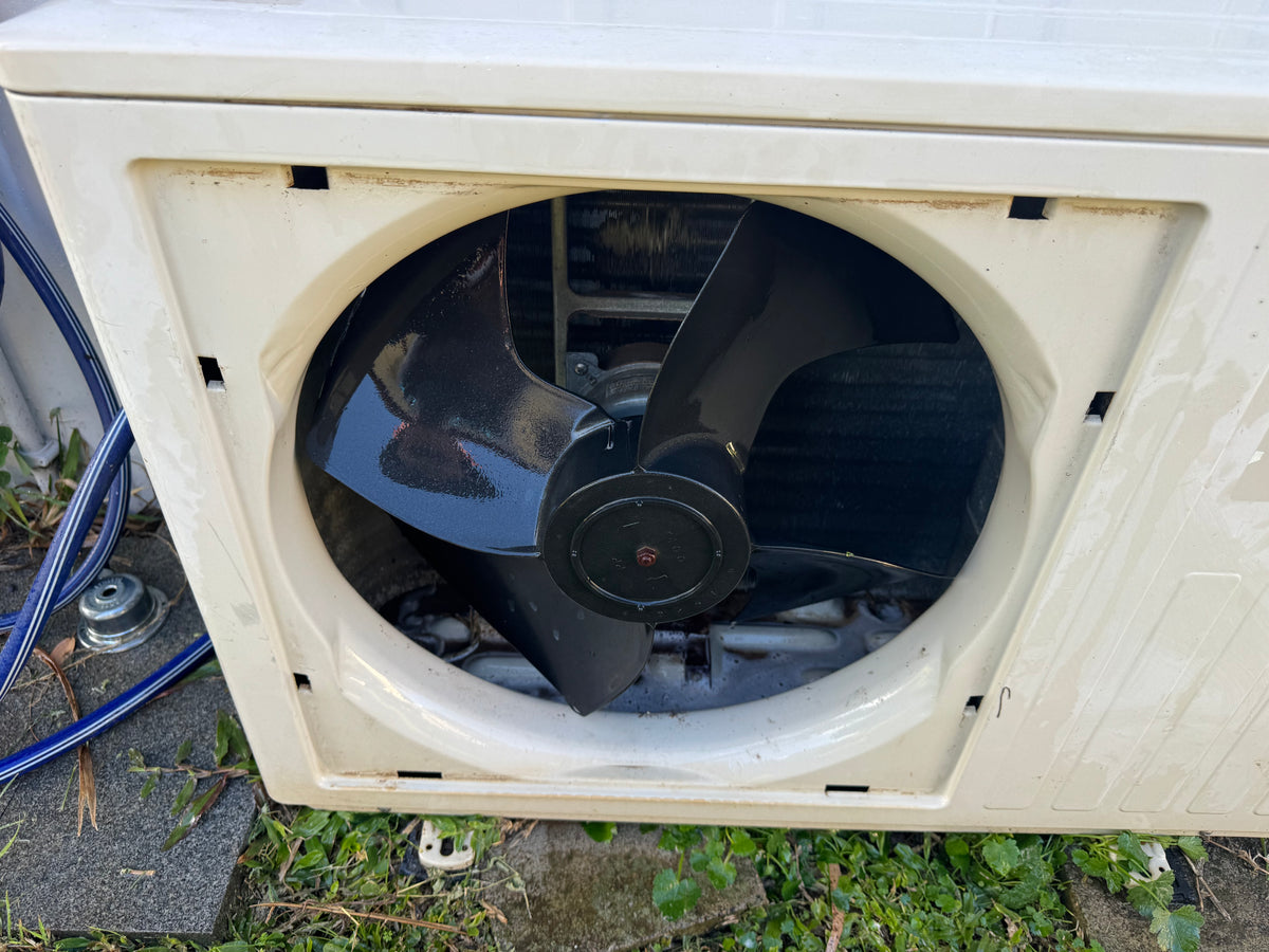 Outdoor split system condenser unit ready for cleaning