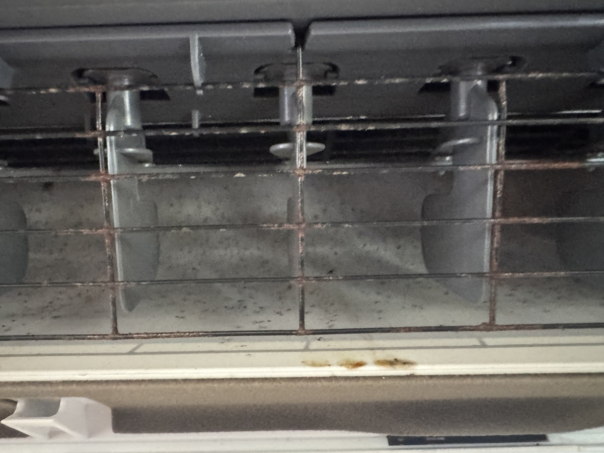 Before cleaning: Heavy internal build-up removed from this Mitsubishi split system