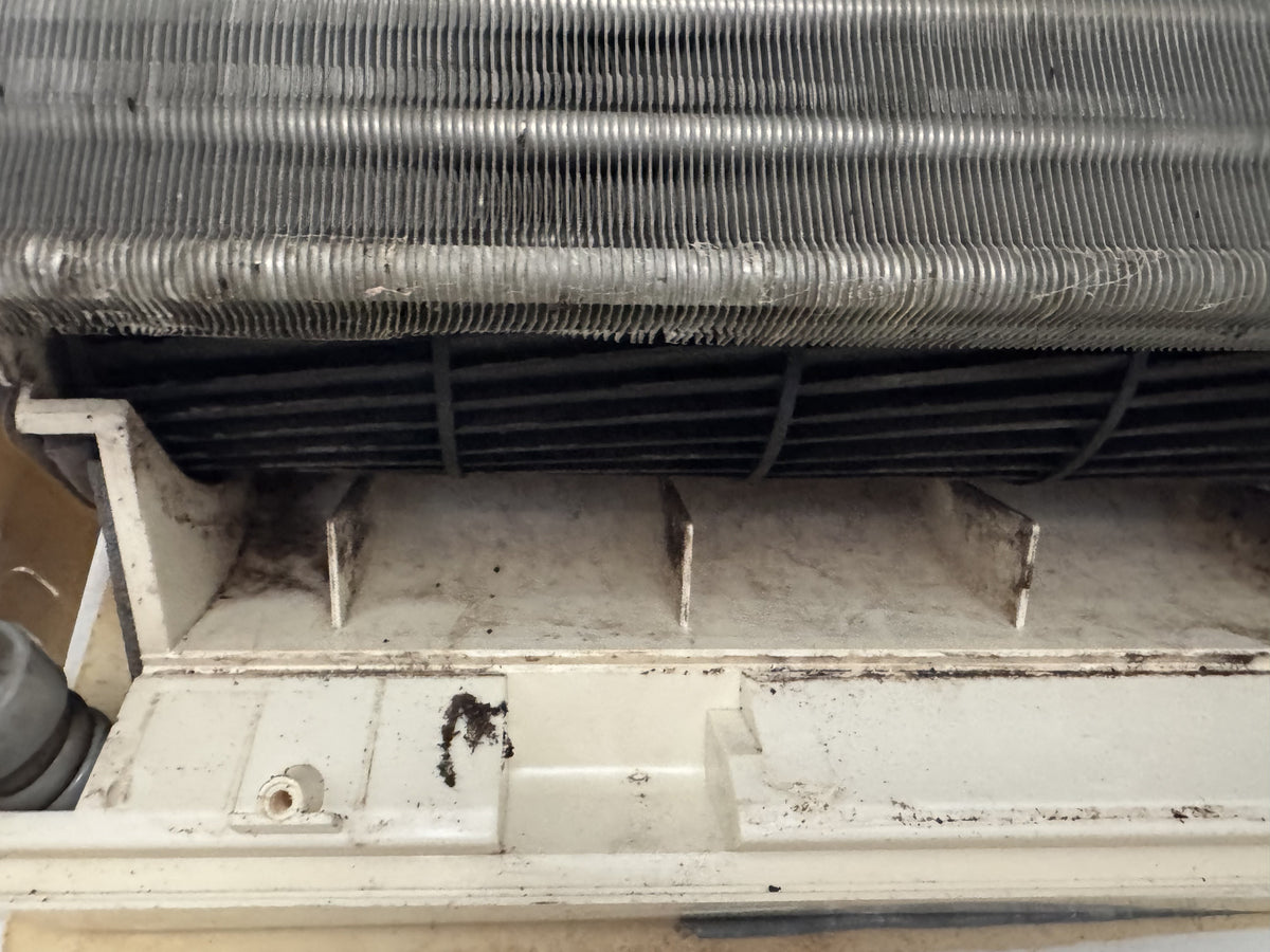 Before cleaning: Heavy mould and greasy build-up removed from two Aspley air cons